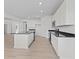Modern kitchen with white cabinets, granite countertops, stainless steel appliances, and a spacious island at 6890 Enclave Dr, McCordsville, IN 46055