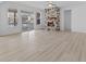 Bright living room features a stone fireplace, ceiling fan, and sliding glass doors leading to the outside at 6890 Enclave Dr, McCordsville, IN 46055