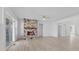 Bright living room with light wood floors, a stone fireplace, a ceiling fan, and white walls at 6890 Enclave Dr, McCordsville, IN 46055