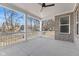 Covered patio features sturdy white columns, a ceiling fan, and serene views of the surrounding landscape at 6890 Enclave Dr, McCordsville, IN 46055