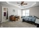 Comfortable bedroom with carpet, a ceiling fan, and a bathroom entrance at 762 Courtney Cir, Danville, IN 46122