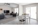 Open-concept dining area adjacent to the living room featuring natural light from sliding glass doors at 762 Courtney Cir, Danville, IN 46122