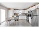 Bright kitchen featuring white cabinets, stainless steel appliances, and a dining table at 762 Courtney Cir, Danville, IN 46122