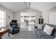 Cozy living room featuring an open floor plan leading into the well-lit kitchen and dining area at 762 Courtney Cir, Danville, IN 46122