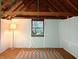 Unfinished attic shows natural light through the window, a patterned rug, and a floor lamp at 83 W Garfield Ave, Martinsville, IN 46151
