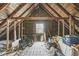 Unfinished attic space with exposed wooden beams, offering potential for customization and additional storage at 83 W Garfield Ave, Martinsville, IN 46151