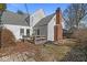 Charming backyard features a wooden deck, brick patio, and lush greenery creating an inviting outdoor space at 83 W Garfield Ave, Martinsville, IN 46151