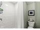 Clean, white tiled shower with modern fixtures and storage basket at 83 W Garfield Ave, Martinsville, IN 46151