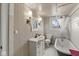 Bathroom features patterned wallpaper, a vintage tub, and modern sink at 83 W Garfield Ave, Martinsville, IN 46151