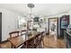 Charming dining room with wooden table and an open view to the kitchen at 83 W Garfield Ave, Martinsville, IN 46151