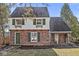 Charming brick home with green shutters, a quaint entrance, and lush landscaping at 83 W Garfield Ave, Martinsville, IN 46151