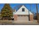 Spacious two-car garage features brick siding, a gable roof, and a well-manicured lawn enhancing curb appeal at 83 W Garfield Ave, Martinsville, IN 46151