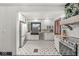 Bright kitchen with white cabinets, stainless steel appliances, tile floor and black farmhouse sink at 83 W Garfield Ave, Martinsville, IN 46151