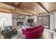 Cozy living room with wood-beamed ceilings, a brick fireplace, and a comfortable seating area at 83 W Garfield Ave, Martinsville, IN 46151