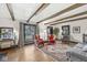 Comfortable living room with exposed beams, hardwood floors, and large windows at 83 W Garfield Ave, Martinsville, IN 46151