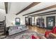 Spacious living room with exposed beams, hardwood floors, and stylish decor at 83 W Garfield Ave, Martinsville, IN 46151