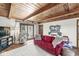 Bright living room with exposed wood-beamed ceilings and access to an outdoor patio at 83 W Garfield Ave, Martinsville, IN 46151