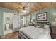 Charming bedroom features wood paneled walls, a ceiling fan, and an ensuite bathroom with modern fixtures at 83 W Garfield Ave, Martinsville, IN 46151
