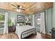 Cozy bedroom features wood floors, a ceiling fan, and windows with sheer curtains at 83 W Garfield Ave, Martinsville, IN 46151