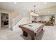 Finished basement with carpeted floor, pool table, and stairs leading to the upper level at 9126 Pinecreek Ct, Indianapolis, IN 46256