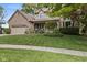 The beautiful home showcases a brick facade, mature landscaping, and a two-car garage at 9126 Pinecreek Ct, Indianapolis, IN 46256