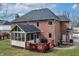 A well-kept backyard featuring a screen porch, spacious deck, and timeless brick home at 9914 Springstone Rd, Fishers, IN 46055