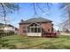 Spacious backyard showcases the brick home with screened-in porch and attached deck at 9914 Springstone Rd, Fishers, IN 46055