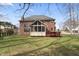Expansive backyard with well-maintained lawn, a screen porch, and a beautiful red brick house at 9914 Springstone Rd, Fishers, IN 46055