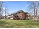Expansive lawn highlights the brick home featuring a screened porch and outdoor deck at 9914 Springstone Rd, Fishers, IN 46055