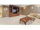 Cozy basement sitting area featuring built-in shelving, a comfortable sofa, and stylish decor at 9914 Springstone Rd, Fishers, IN 46055