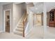 Finished basement featuring carpeted stairs with wooden handrail, neutral walls, and an adjacent bathroom at 9914 Springstone Rd, Fishers, IN 46055