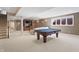 Basement with billiards table, carpeted flooring, and built-in shelving, perfect for recreation and relaxation at 9914 Springstone Rd, Fishers, IN 46055