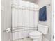 Bathroom featuring a white shower curtain, toilet, and a blue towel on a silver towel rack at 9914 Springstone Rd, Fishers, IN 46055