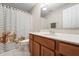 Well-lit bathroom featuring a floral shower curtain, vanity with sink, and a large mirror at 9914 Springstone Rd, Fishers, IN 46055