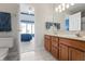 Bright bathroom with a double vanity and access to the bedroom provides both style and convenience at 9914 Springstone Rd, Fishers, IN 46055