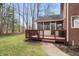 Outdoor deck area of a brick home, featuring a screen porch and barbeque grill at 9914 Springstone Rd, Fishers, IN 46055