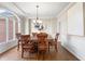 Formal dining room with hardwood floors, wainscoting, chandelier lighting, and large windows at 9914 Springstone Rd, Fishers, IN 46055