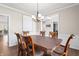 Dining room with hardwood floors, chandelier, and large window, perfect for Gathering gatherings at 9914 Springstone Rd, Fishers, IN 46055