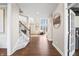 Inviting home foyer featuring hardwood floors, staircase, and a view to the dining and living areas at 9914 Springstone Rd, Fishers, IN 46055