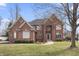 Charming two-story brick home featuring a manicured lawn and elegant architectural details at 9914 Springstone Rd, Fishers, IN 46055