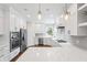 Bright kitchen with white cabinets, stainless steel appliances, and a quartz countertop at 9914 Springstone Rd, Fishers, IN 46055