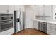 Modern kitchen showcasing stainless steel appliances, white cabinets, quartz countertops, and hardwood flooring at 9914 Springstone Rd, Fishers, IN 46055