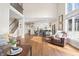 Spacious living room featuring hardwood floors with couches and view to stairs and kitchen at 9914 Springstone Rd, Fishers, IN 46055