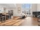 Bright living room featuring hardwood floors, large windows and a dining area at 9914 Springstone Rd, Fishers, IN 46055