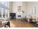 Bright living room with fireplace, high ceiling, large windows and hardwood floors at 9914 Springstone Rd, Fishers, IN 46055