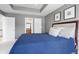 Comfortable main bedroom with a blue duvet, gray walls, and an ensuite bathroom visible in background at 9914 Springstone Rd, Fishers, IN 46055