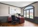 Bright home office featuring a large window, hardwood floors, custom built-ins, and comfortable seating at 9914 Springstone Rd, Fishers, IN 46055