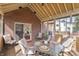 Inviting screen porch with brick wall and dining area at 9914 Springstone Rd, Fishers, IN 46055