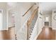 Staircase with carpet and wood railing and view to living room at 9914 Springstone Rd, Fishers, IN 46055