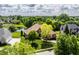 Aerial view of the home and the manicured lawn, landscaping and neighborhood pond at 10541 Titan Run, Carmel, IN 46032